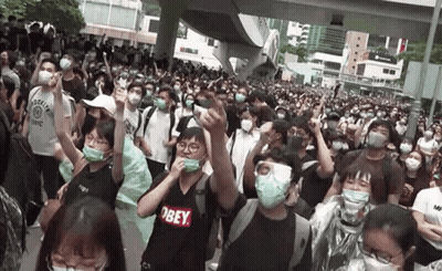 Crowd In Masks And Obey Shirts GIF