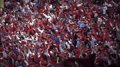 Crowd In Red Hats And Scarves With Man In Number 20 Shirt GIF