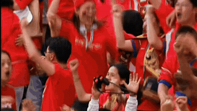 Crowd In Red Shirts Watching Soccer Game GIF