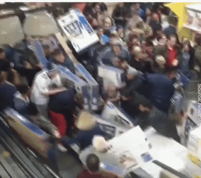 Crowd In Store With AA Sign GIF