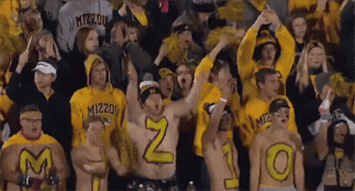 Crowd In Yellow Shirts With M And O On Backs GIF