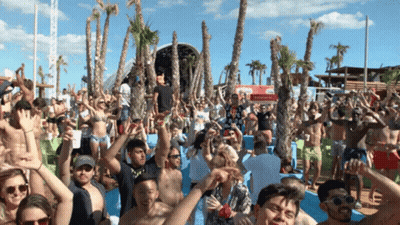 Crowd Of People At Beach Party With Coca-Cola Sign GIF