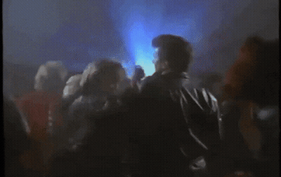 Crowd Of People Dancing In Dark Room With Blue Lights GIF