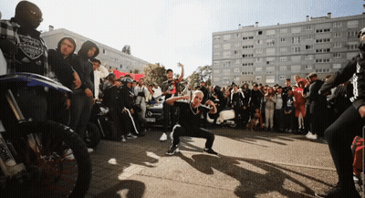 Crowd Outside Building With Harley Davidson Shirt GIF