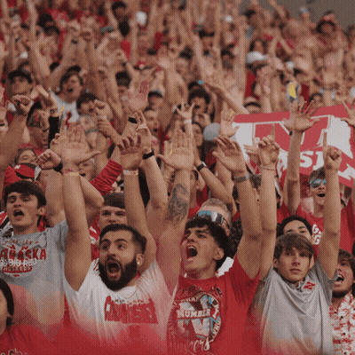 Crowd Raising Arms With Man In Number 16 Shirt GIF