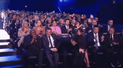 Crowd Sitting In Theater Watching Presentation GIF