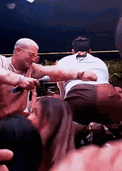 Crowd Surrounding Man With Microphone GIF