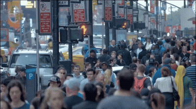 Crowd Walking Down Street With No Stopping Sign GIF