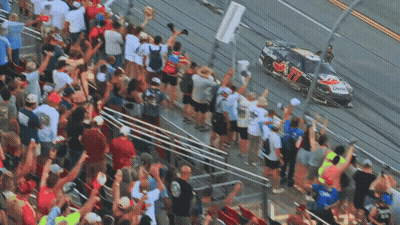 Crowd Watching Race Car Number 77 GIF