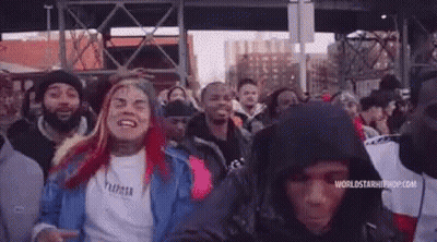Crowd With Person In Hoodie GIF