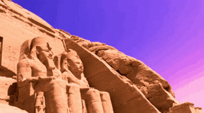 Crowned Man Statue On Rock Blue Sky GIF