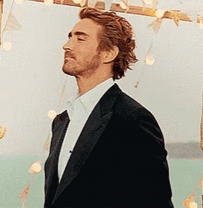 Crying Baby Held By Woman In Crowd GIF