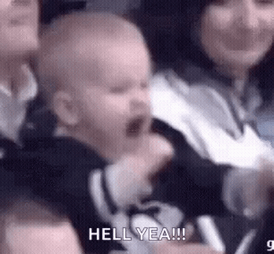 Crying Baby Held By Woman In Crowd GIF