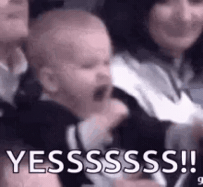 Crying Baby Held By Woman In Crowd GIF