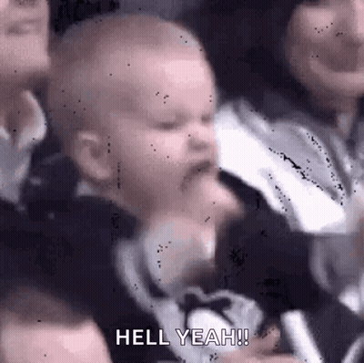 Crying Baby Held By Woman In Crowd GIF