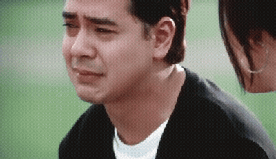 Crying Man Standing Next To A Woman Looking At Him GIF