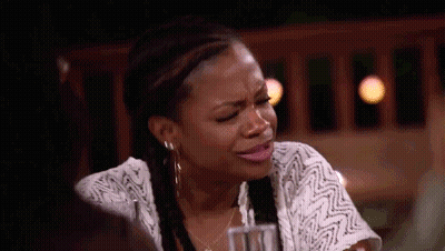 Crying Woman Sitting At Table With Drink GIF