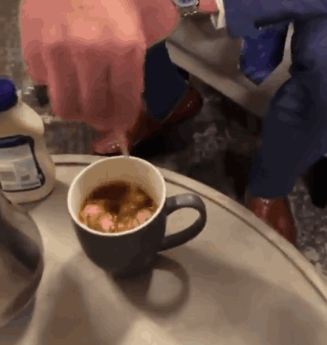 Cup Of Coffee Next To Milk Bottle GIF