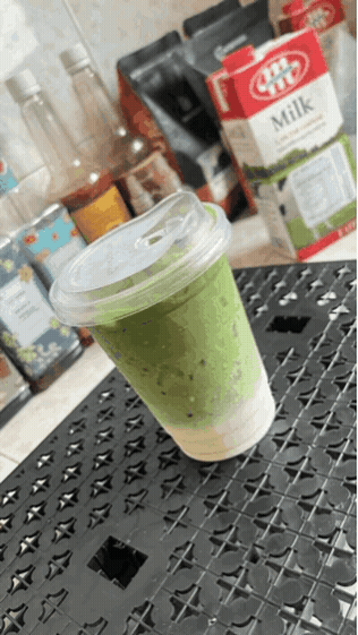 Cup Of Green Milk Next To JBT Milk Carton GIF
