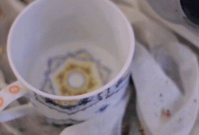 Cup Of Hot Chocolate Poured Into Napkin GIF