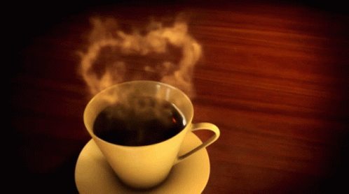 Cup Of Steaming Coffee On Saucer On Wooden Table GIF