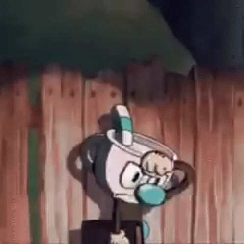 Cuphead Is Standing In Front Of A Wooden Fence . GIF