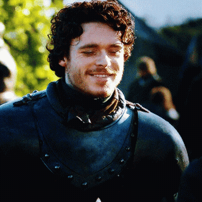 Curly Bearded Man In Armor And Scarf GIF