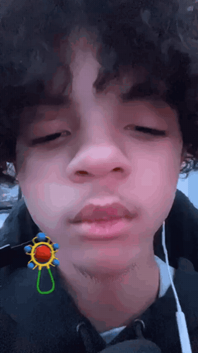 Curly Boy Funny Face With Ear Buds And Earrings GIF