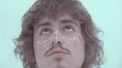 Curly Hair Man With Mustache And White Dots GIF