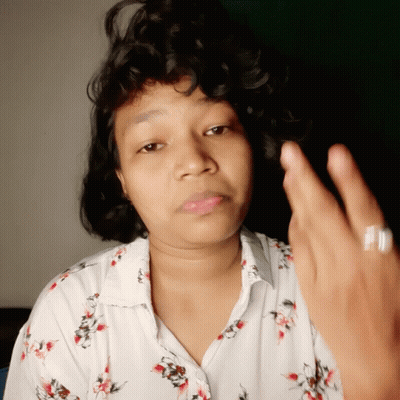 Curly Hair Woman In White Floral Giving Middle Finger GIF