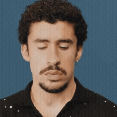Curly-Haired, Bearded Man Making Funny Face Eyes Closed GIF