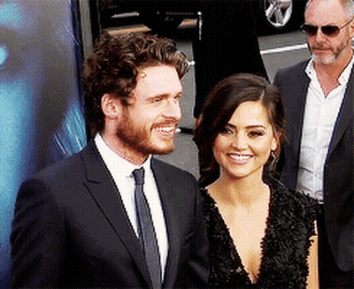 Curly Haired Bearded Man Smiling Next To Another Man GIF