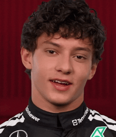 Curly Haired Man In Black And White Shirt Says Some Nice GIF