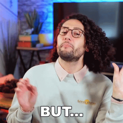 Curly Haired Man In Glasses And Sweater Saying But GIF