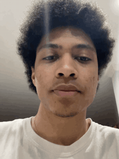Curly Haired Man In White Shirt Looking At Camera GIF