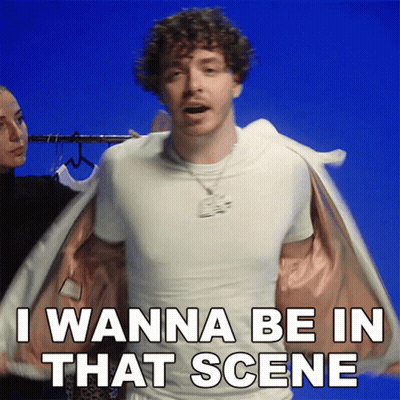 Curly Haired Man In White T-Shirt And Jacket Says I Wanna Be In That Scene GIF