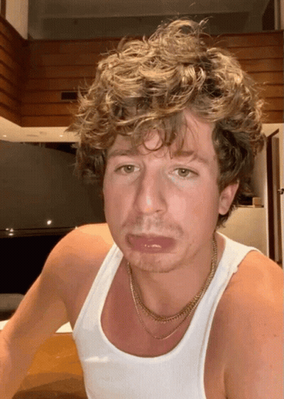 Curly Haired Man In White Tank Top With Gold Chain GIF