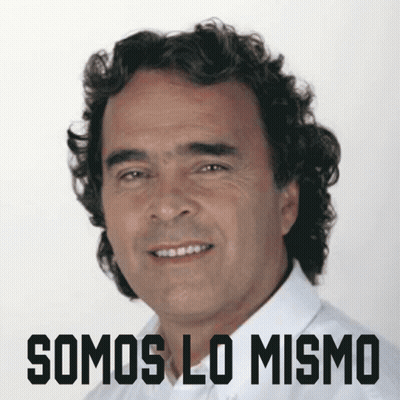 Curly-Haired Man Smiling In Front Of Somos Lo Mismo Sign GIF
