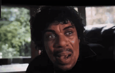 Curly Haired Man With Mustache Looking At Camera GIF