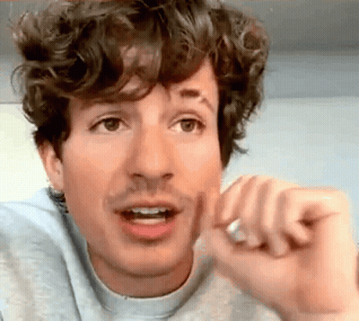 Curly-Haired Man With Mustache Making Funny Face GIF