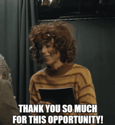 Curly Haired Woman Holding Paper Saying Thank You GIF