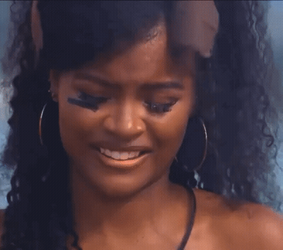 Curly Haired Woman In Bandana By Ocean GIF