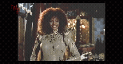 Curly Haired Woman In Leopard Print Costume GIF