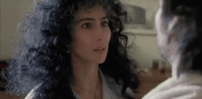 Curly-Haired Woman Looking At Another Woman GIF