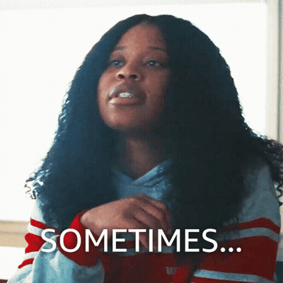 Curly Haired Woman Saying Sometimes In Striped Shirt GIF