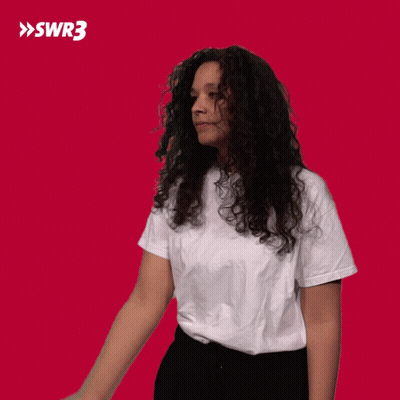 Curly-Haired Woman White T-Shirt Black Pants Red SWR3 GIF