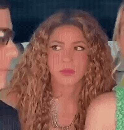 Curly-Haired Woman With Necklace Beside Man And Woman GIF