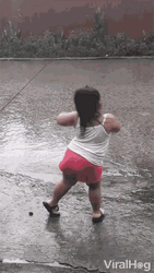 Cute Little Kid Dancing In The Rain GIF