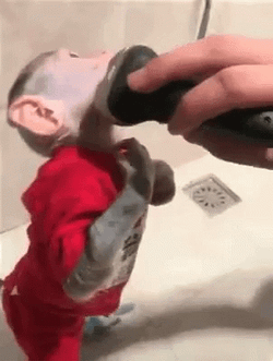 Cute Monkey Tries Shaving In Face GIF