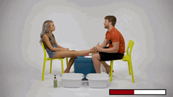 Cute Sitting Couple Doing Foot Massage GIF